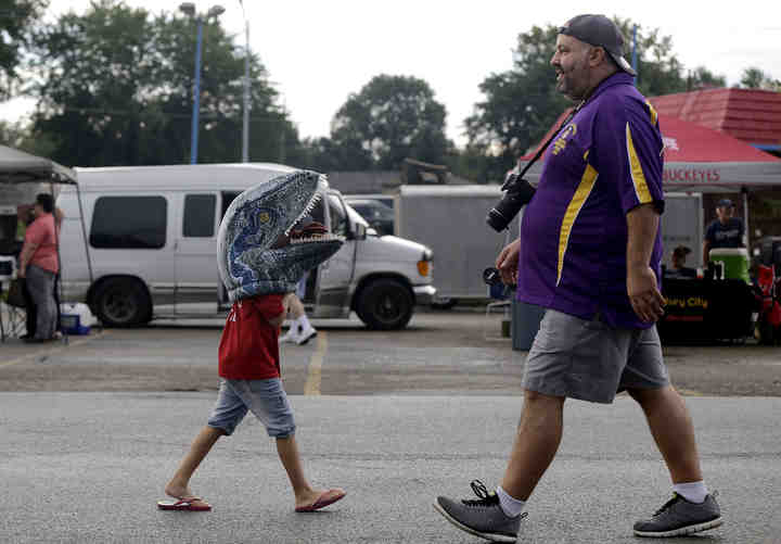 Ashley Reed, 7, of Blacklick, and Lou Salbati, of Reynoldsburg, cross paths walking around the fourth annual National Night Out event, hosted by the Reynoldsburg Division of Police.  (Shane Flanigan / ThisWeek Community News)